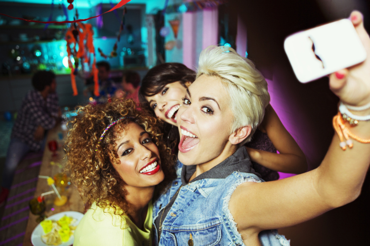 Women taking self-portrait at party