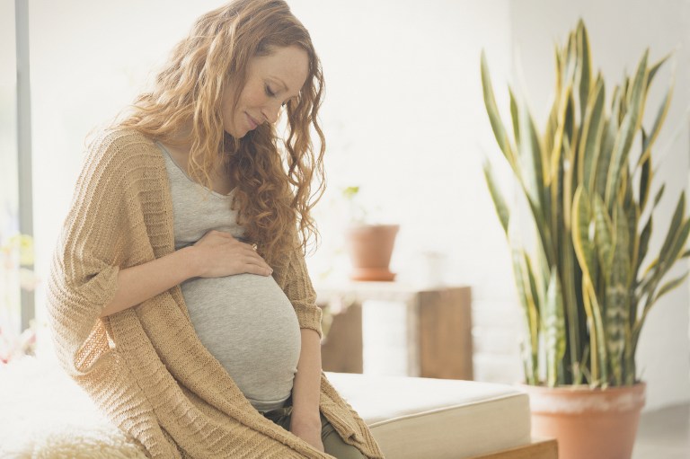 pregnant women holding stomach